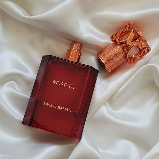 Red Swiss Arabian Rose 01 perfume bottle on white fabric