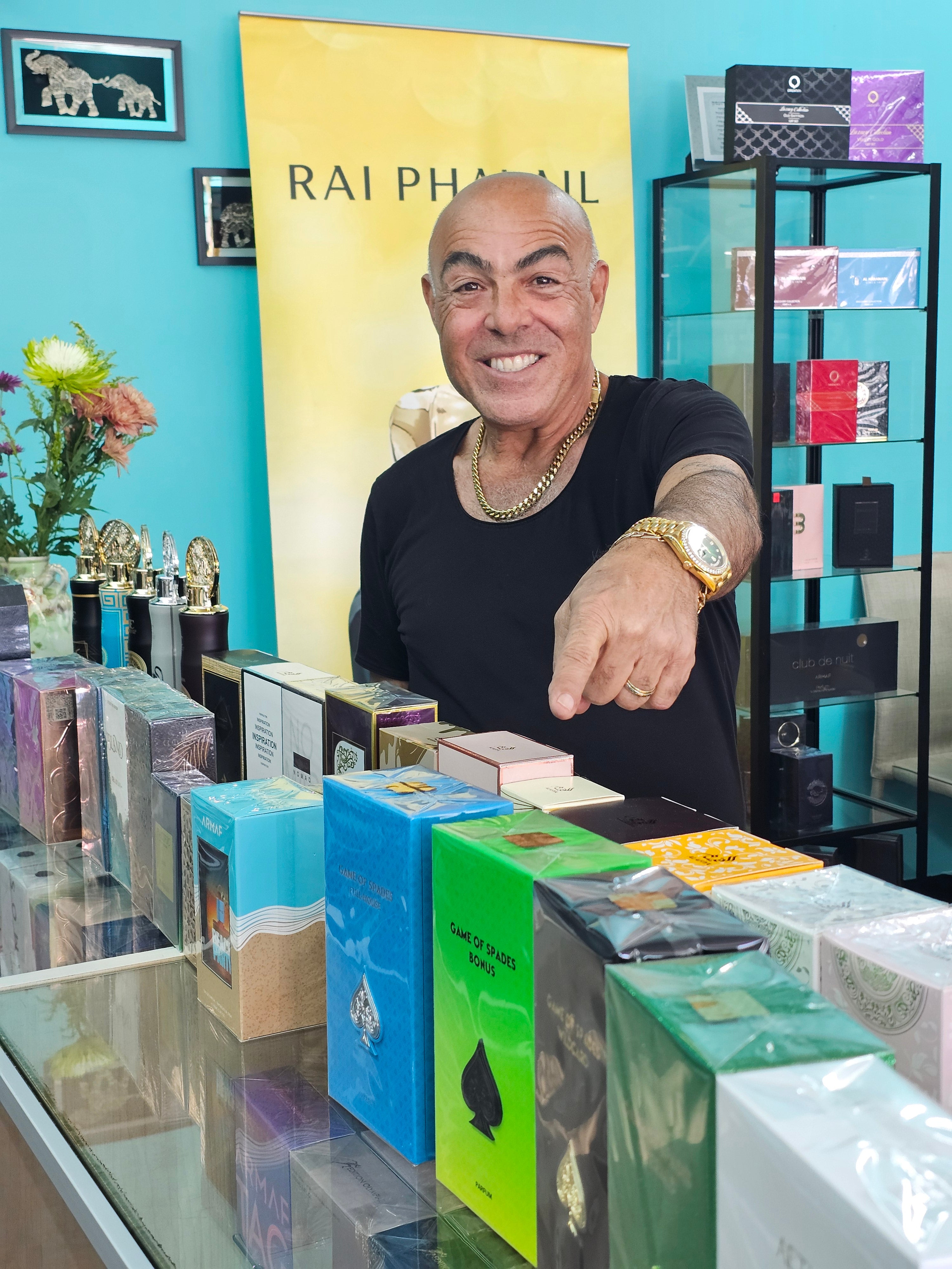 Man standing in a store with shelves displaying various products, including books and decorative items.