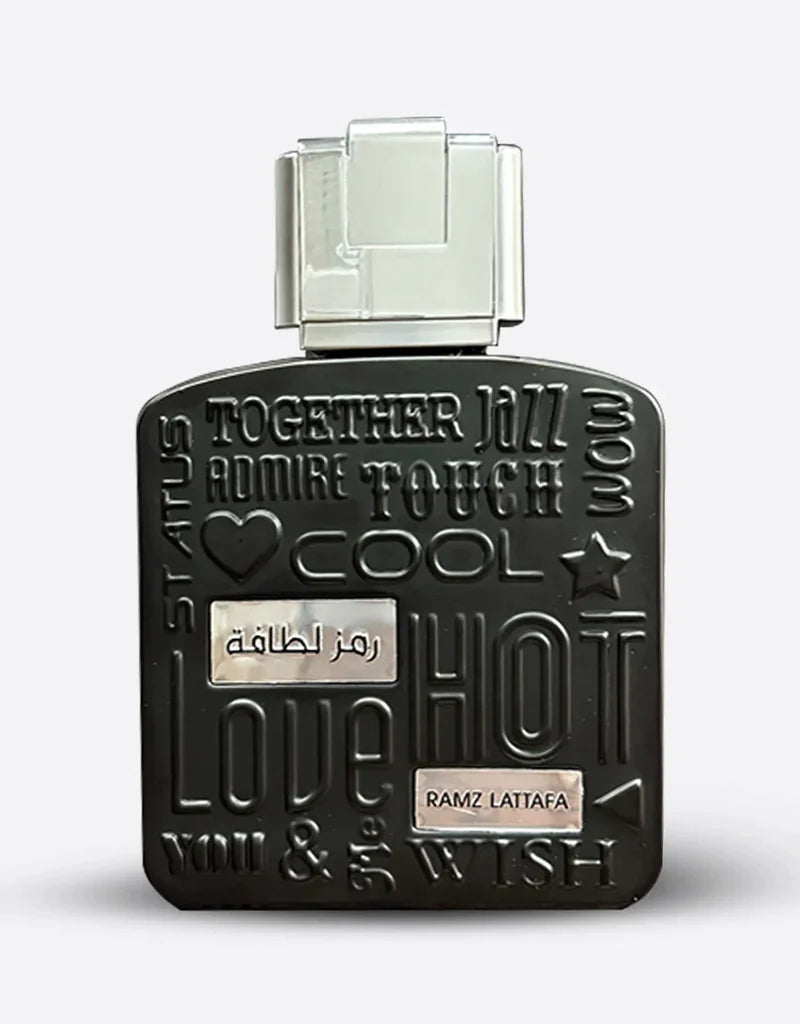 Lattafa Ramz Silver 100 ml bottle – fresh apple aromatic fragrance with vanilla amber woody base.