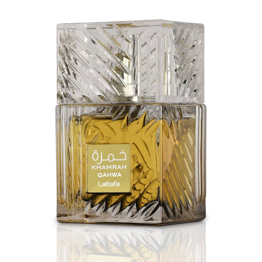 Glass perfume bottle with intricate design and gold label on a white background